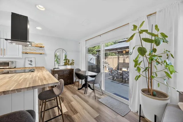 a backyard of a house with fountain table and chairs