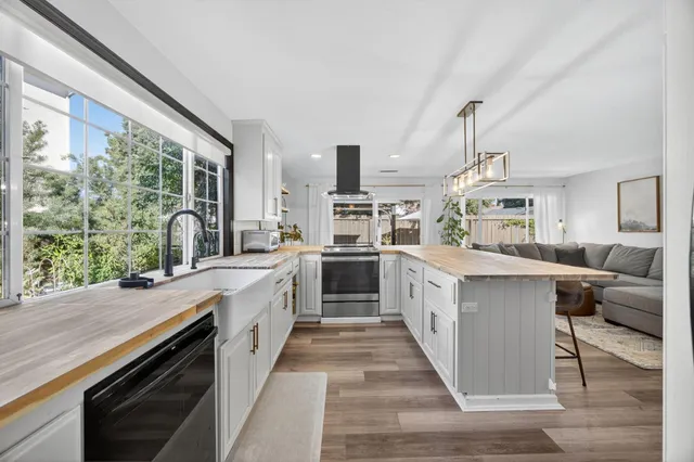 a view of a house with a yard and sitting area