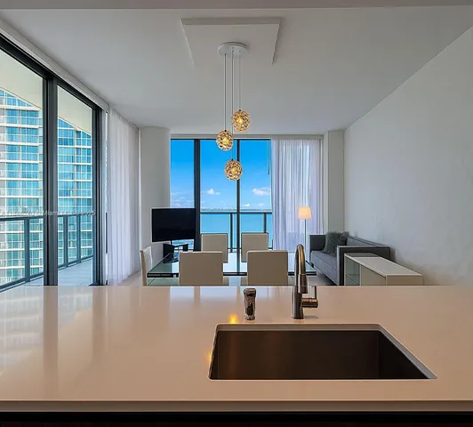 a living room with furniture and large window