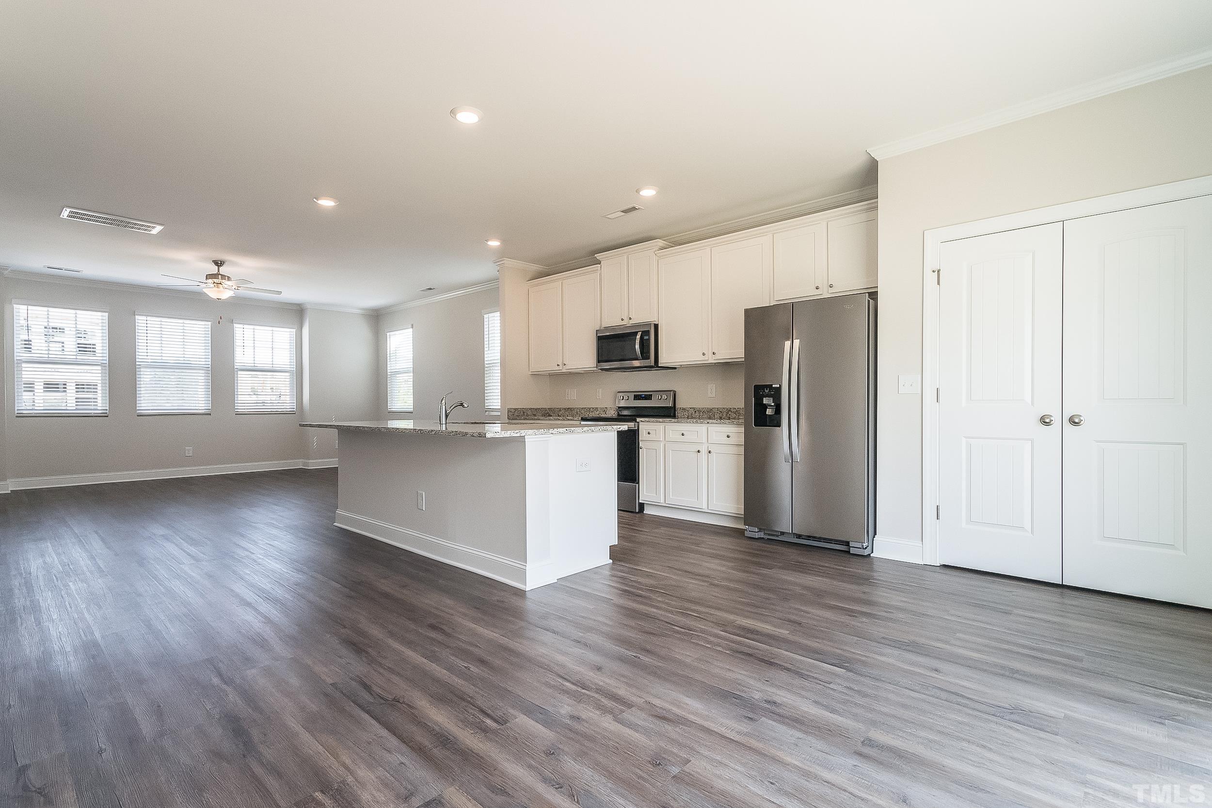 6925 Point Bar Place Raleigh, NC 27616 - Photo 3 of 10 a view of kitchen with granite countertop stainless steel appliances refrigerator sink and microwave