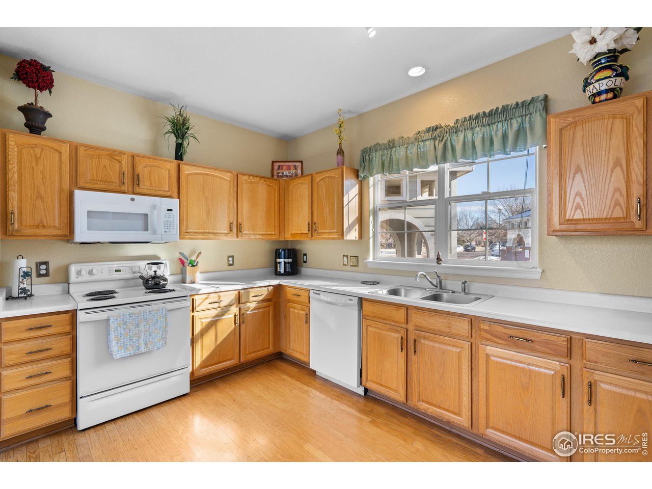10351 Cook Way Thornton, CO 80229 - Photo 13 of 30 a kitchen with a sink stove and cabinets
