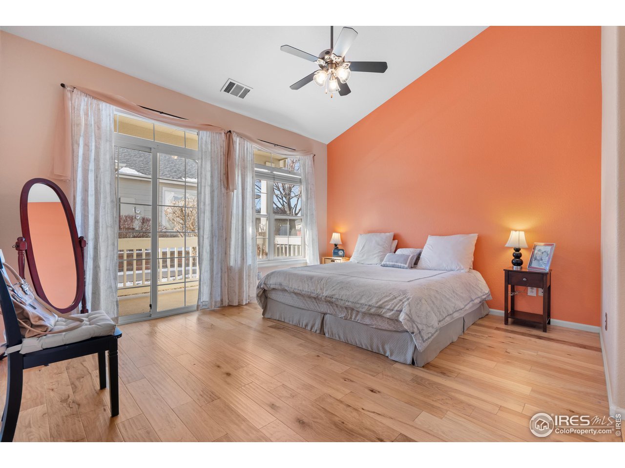 10351 Cook Way Thornton, CO 80229 - Photo 14 of 30 a spacious bedroom with a bed a dresser with wooden floor