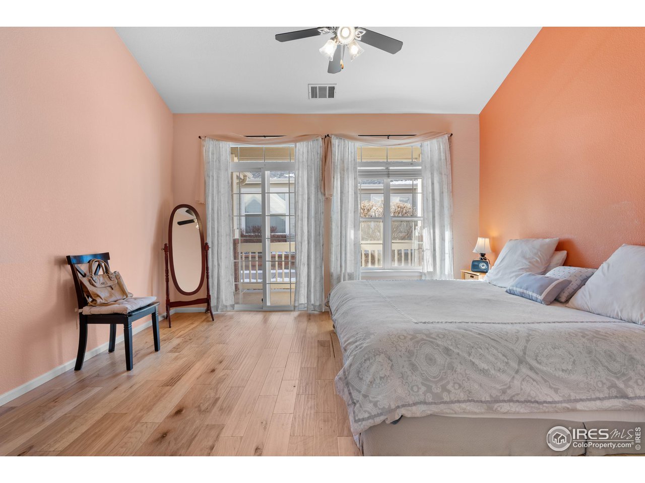 10351 Cook Way Thornton, CO 80229 - Photo 15 of 30 a bedroom with a bed a dresser with wooden floor