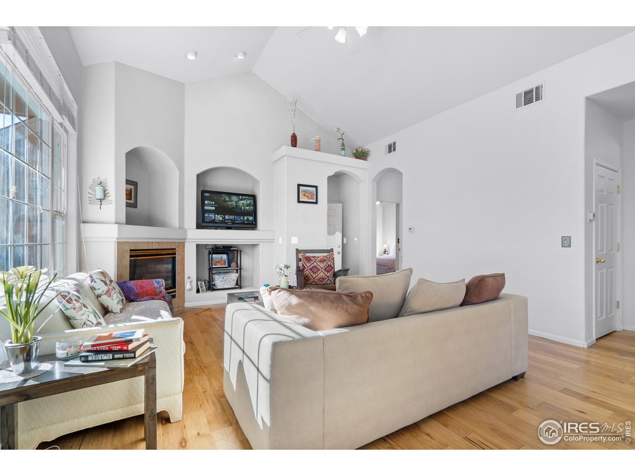 10351 Cook Way Thornton, CO 80229 - Photo 6 of 30 a living room with furniture fireplace and a fireplace