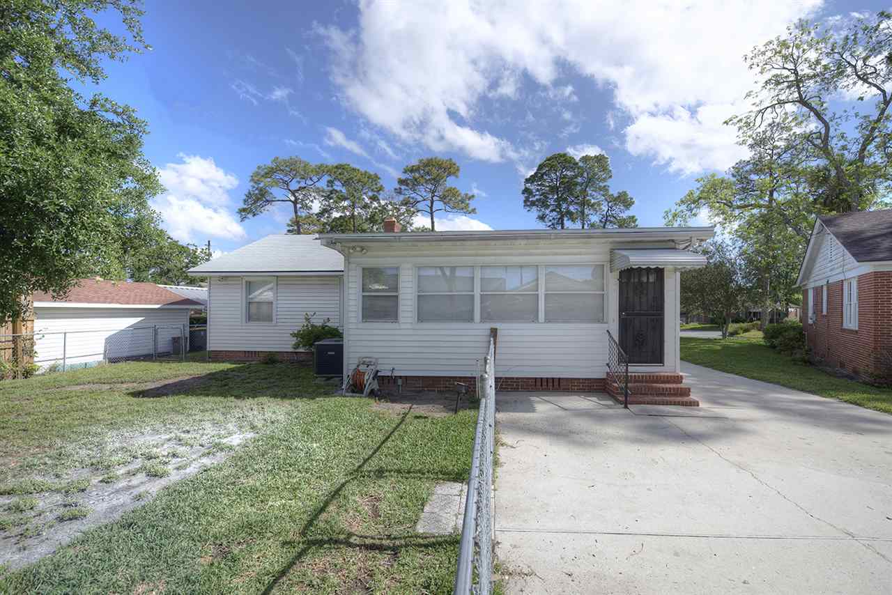 2224 Southampton Road Jacksonville, FL 32207 - Photo 22 of 25 a front view of a house with a yard and garage