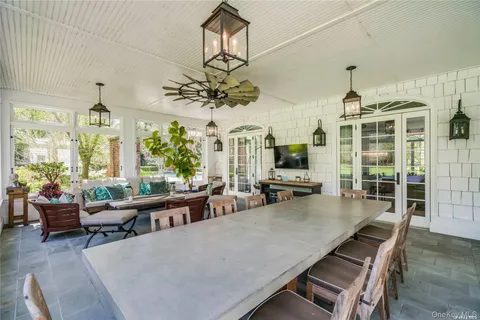 a living room with furniture a chandelier and a flat screen tv