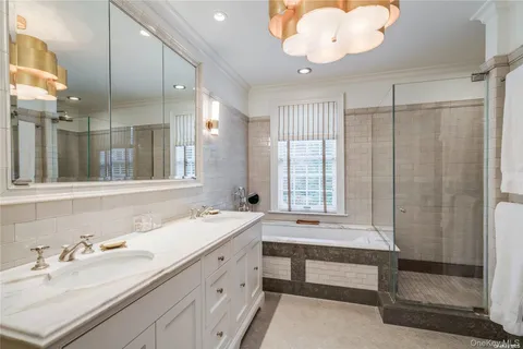 a bathroom with a double vanity sink mirror and double