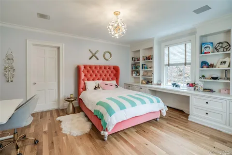 a bedroom with a bed and a chandelier