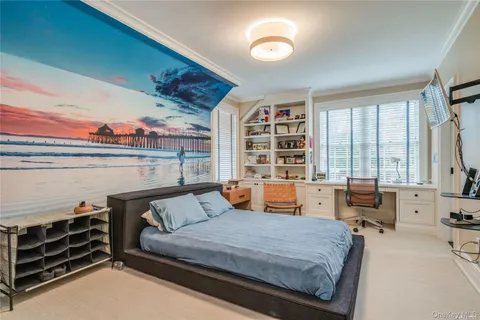 a bedroom with furniture and a large window