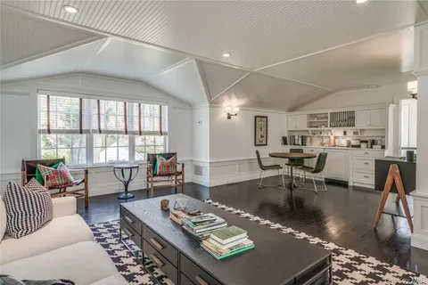 a living room with furniture and a table with kitchen view