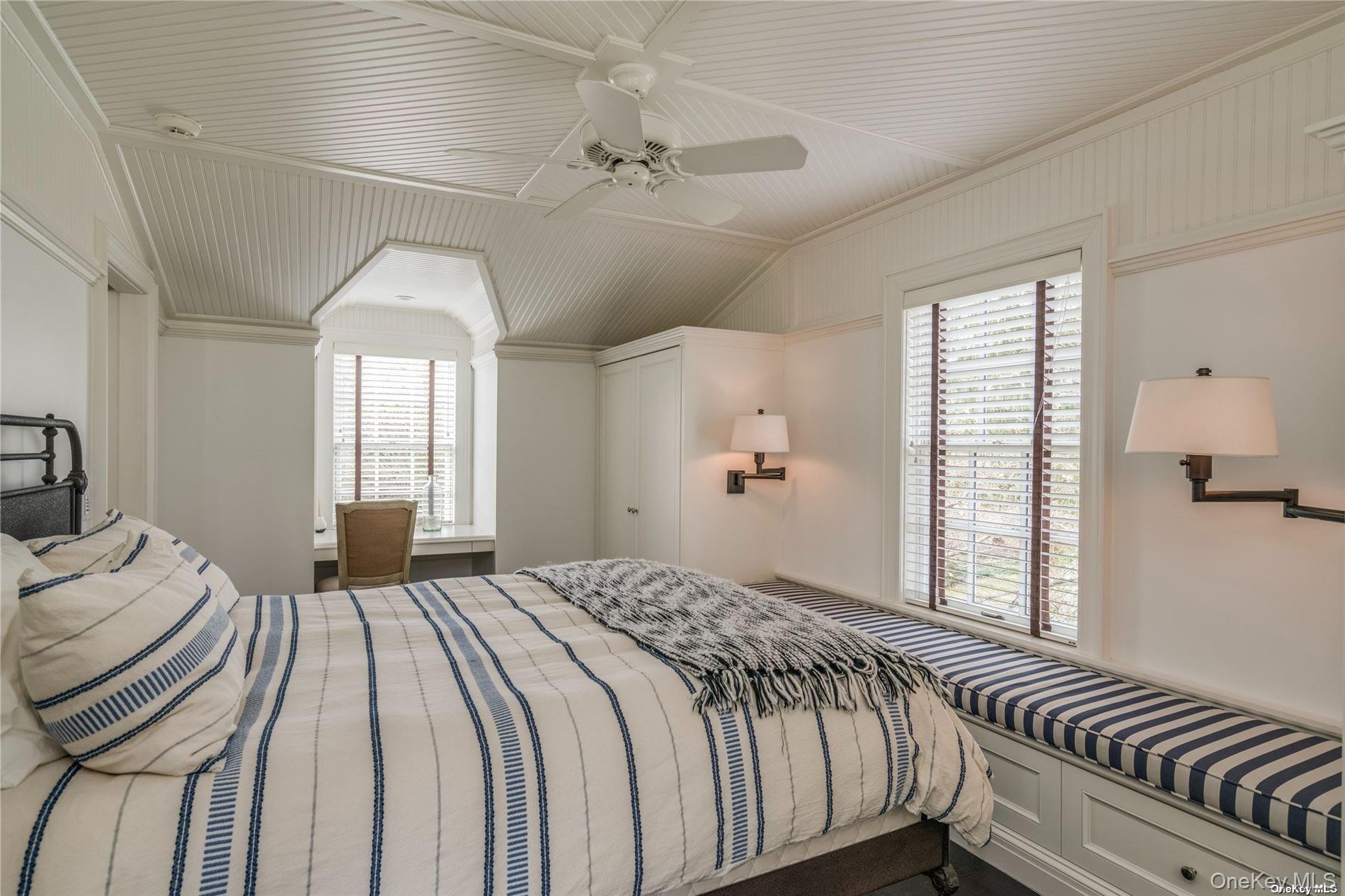 40 Piping Rock Road Locust Valley, NY 11560 - Photo 23 of 33 a bedroom with a large bed and a chandelier