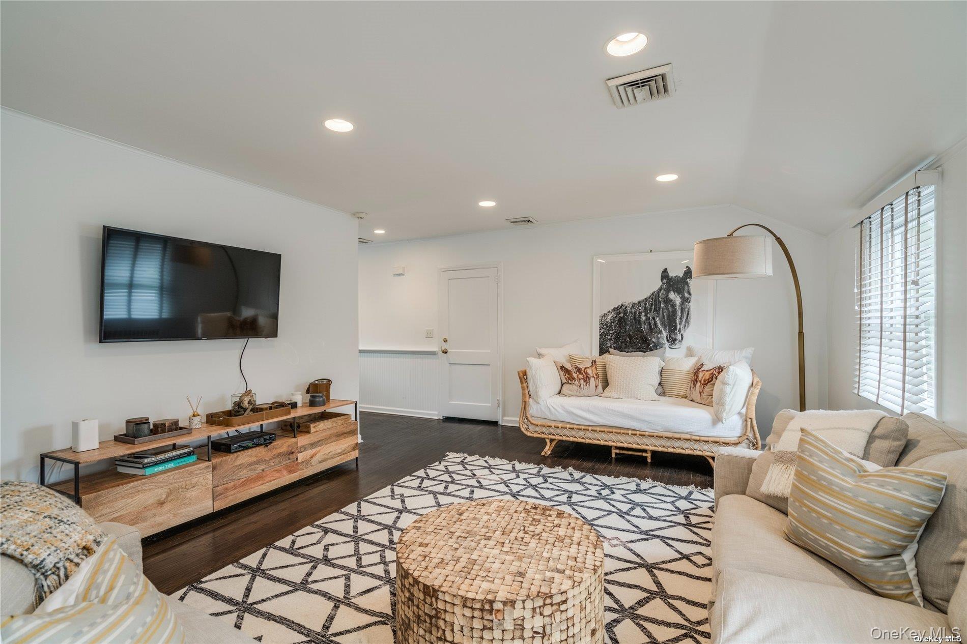 40 Piping Rock Road Locust Valley, NY 11560 - Photo 24 of 33 a living room with furniture and a flat screen tv