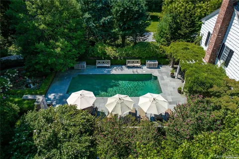 a white house with a yard and outdoor seating