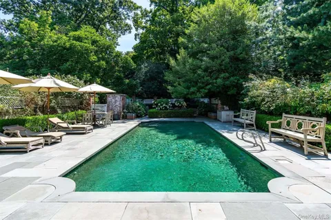 a view of a patio with couches and a fire pit
