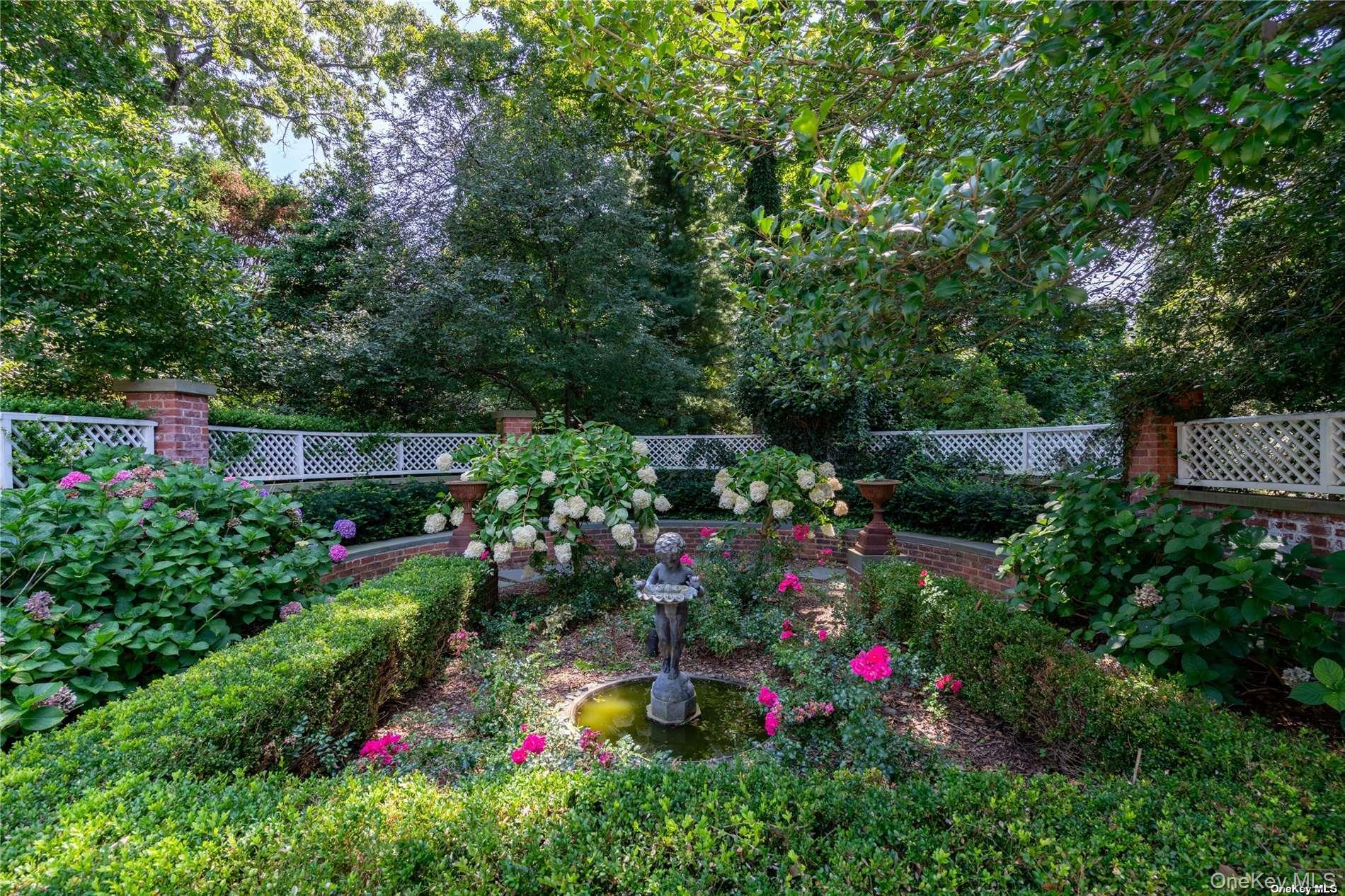 40 Piping Rock Road Locust Valley, NY 11560 - Photo 30 of 33 a view of a garden with large trees