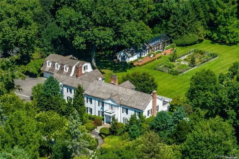 an aerial view of a house with a yard basket ball court and outdoor seating