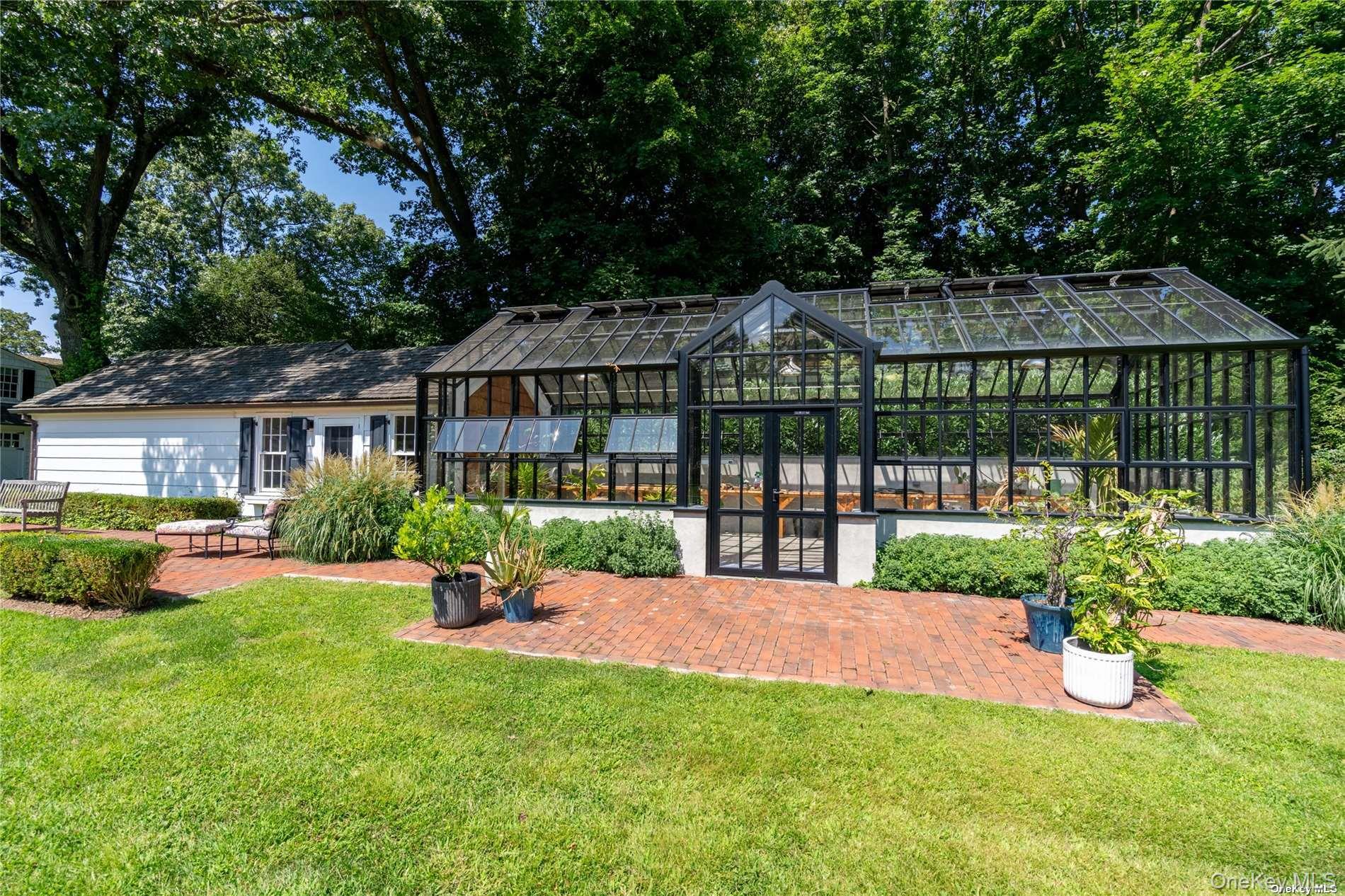 40 Piping Rock Road Locust Valley, NY 11560 - Photo 31 of 33 a front view of house with yard and green space