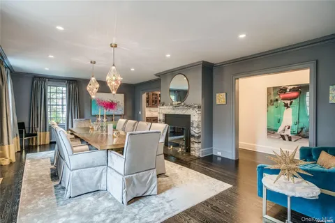a living room with furniture a fireplace and a open kitchen view