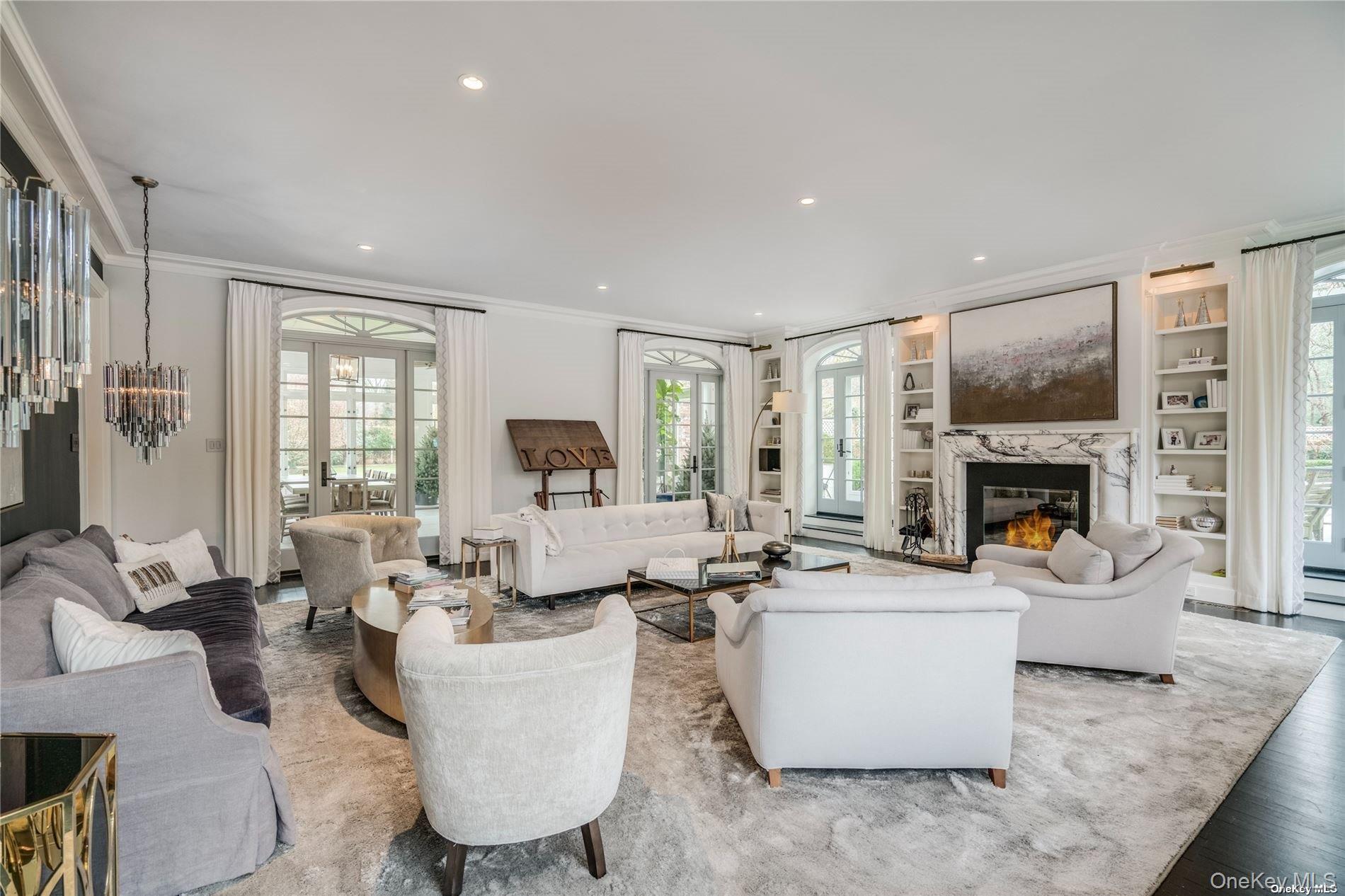 40 Piping Rock Road Locust Valley, NY 11560 - Photo 7 of 33 a living room with furniture a fireplace and a large window