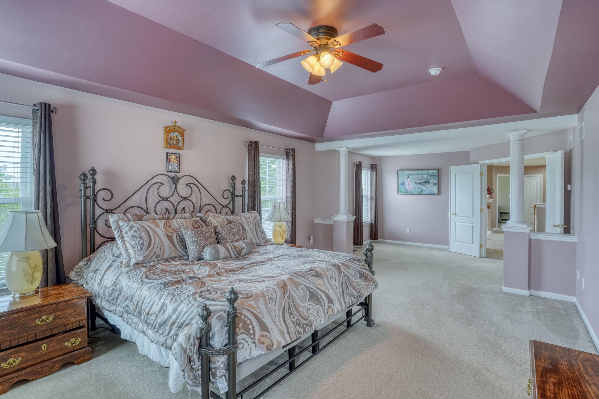 213 Loft Street Townsend, DE 19734 - Photo 51 of 76 a bedroom with a large bed and a chandelier