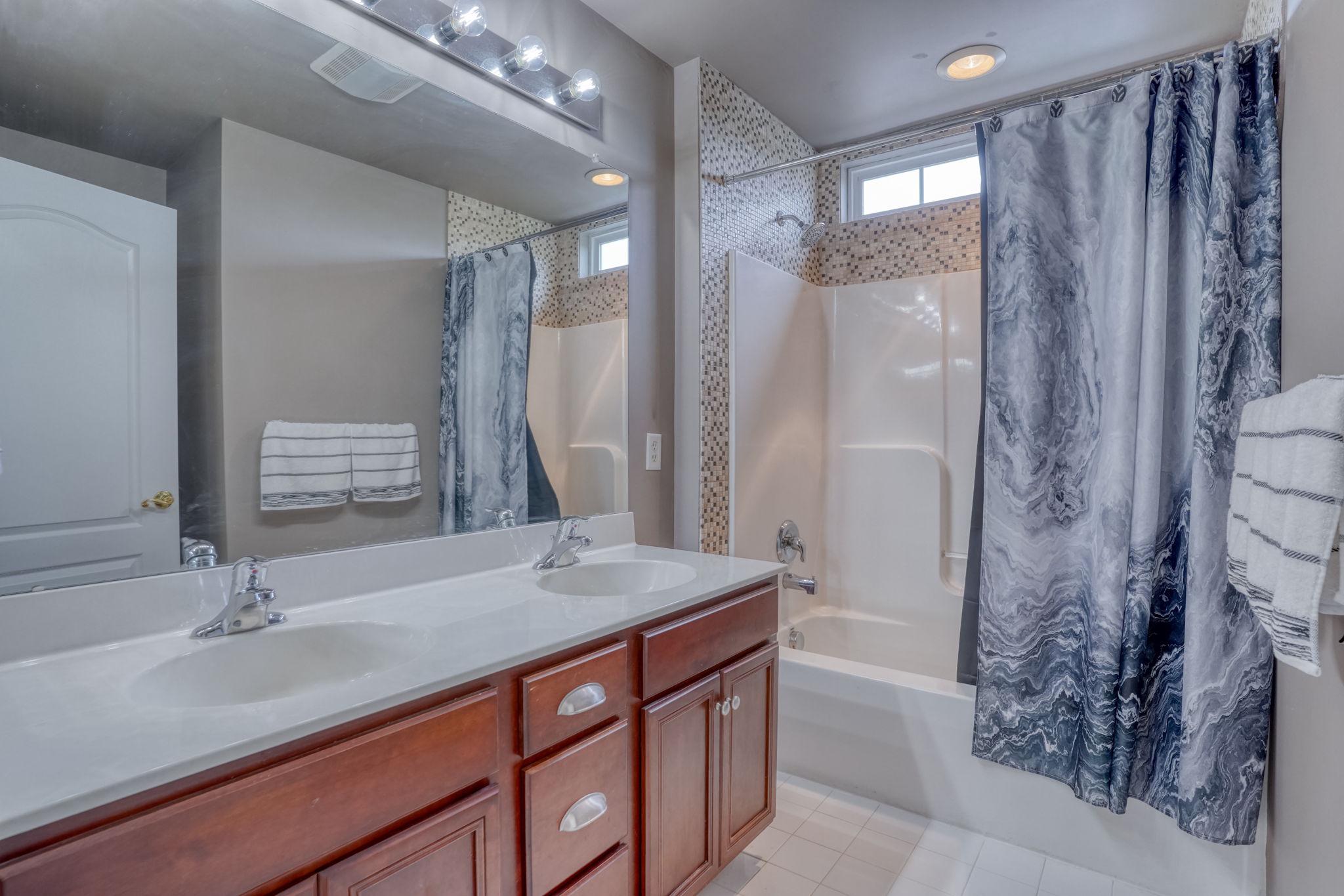 213 Loft Street Townsend, DE 19734 - Photo 60 of 76 a bathroom with a double vanity sink mirror and shower