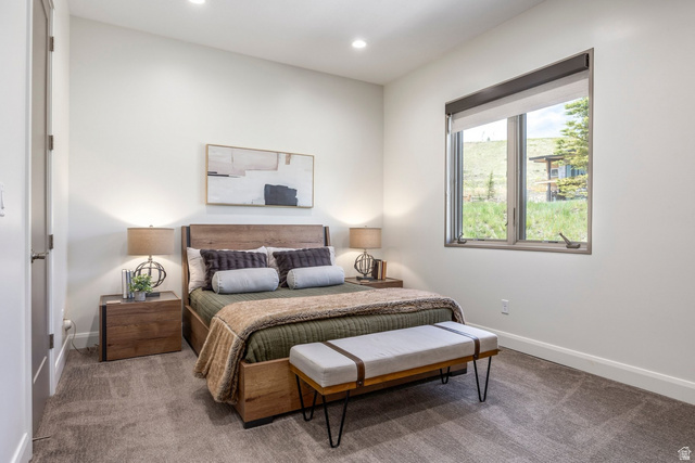 140 West Vista Road Kamas, UT 84036 - Photo 76 of 101 Recessed lighting, wood-finish bed frame, wood-finish nightstands, large window with roller shades, and plush carpet flooring