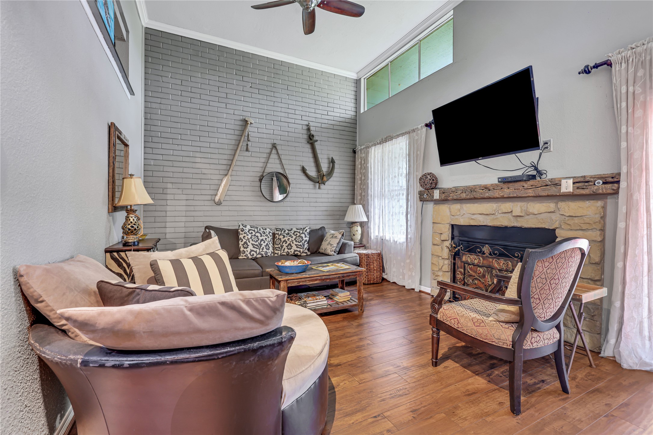 146 Villa Way Coldspring, TX 77331 - Photo 6 of 37 The living area has high ceilings, brick accent wall and wood burning fireplace