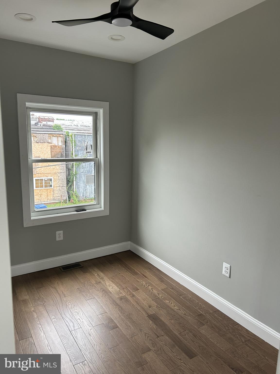 928 Perry Place Northeast Washington, DC 20017 - Photo 11 of 16 an empty room with wooden floor and windows