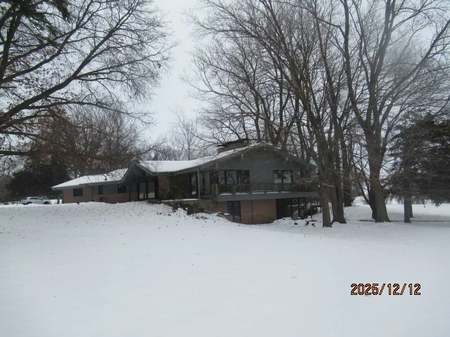 a view of a covered with snow in front of house