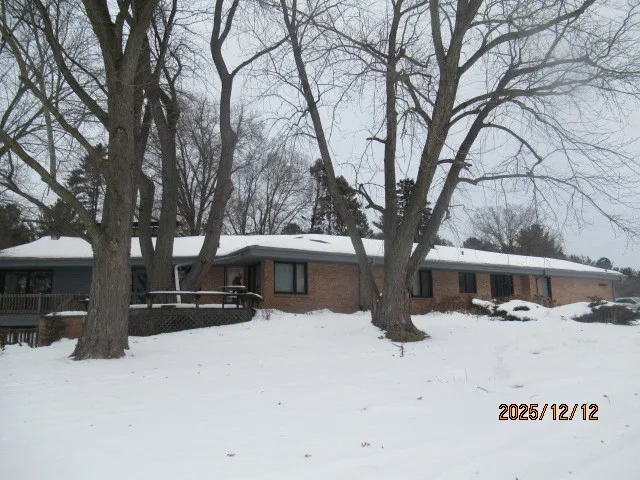 a view of a house with a snow in the yard