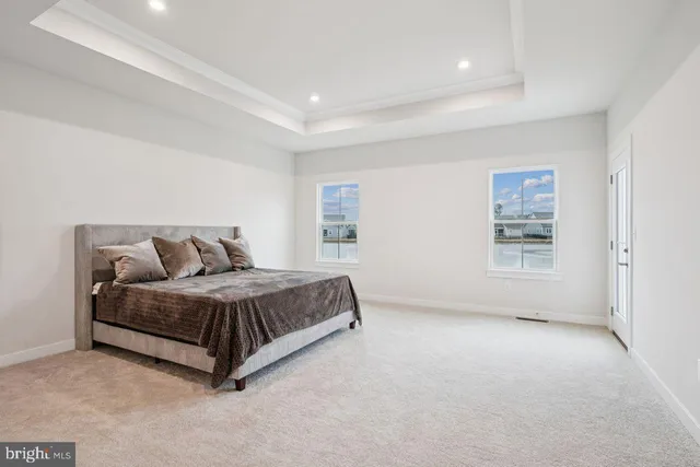 a spacious bedroom with a bed and a couch