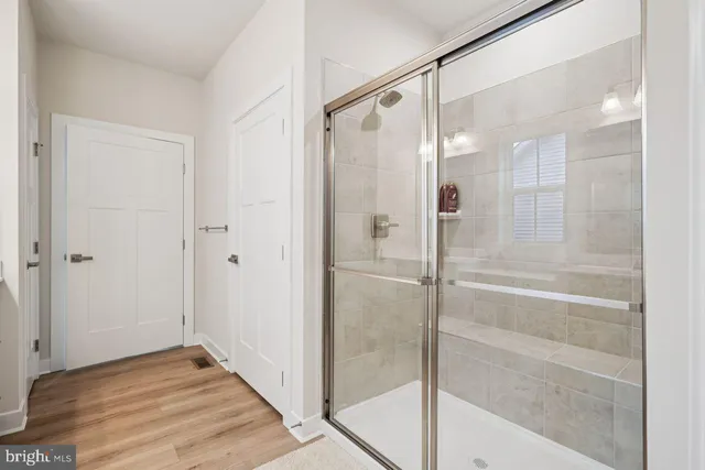 a bathroom with a glass shower door