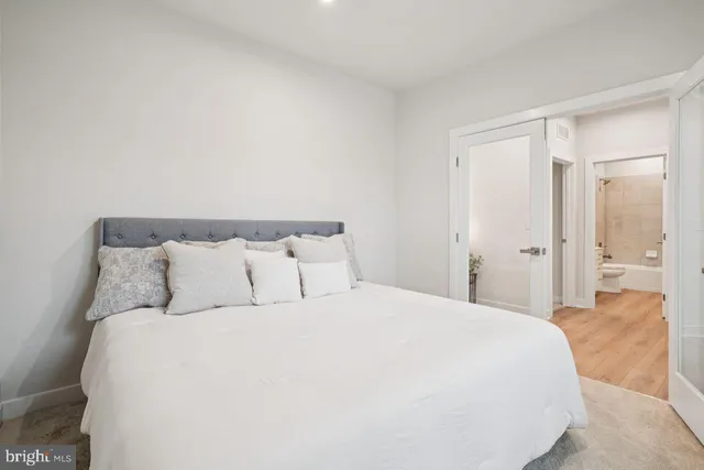 a large bed in a white room