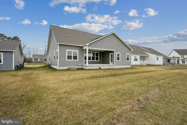 a front view of house with yard and trees