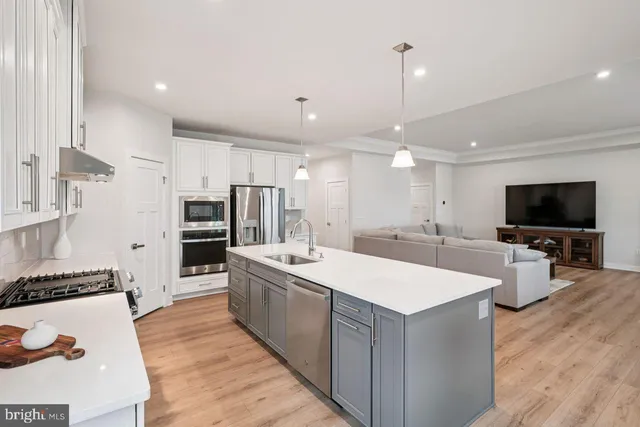 a large kitchen with stainless steel appliances kitchen island a large island in the center