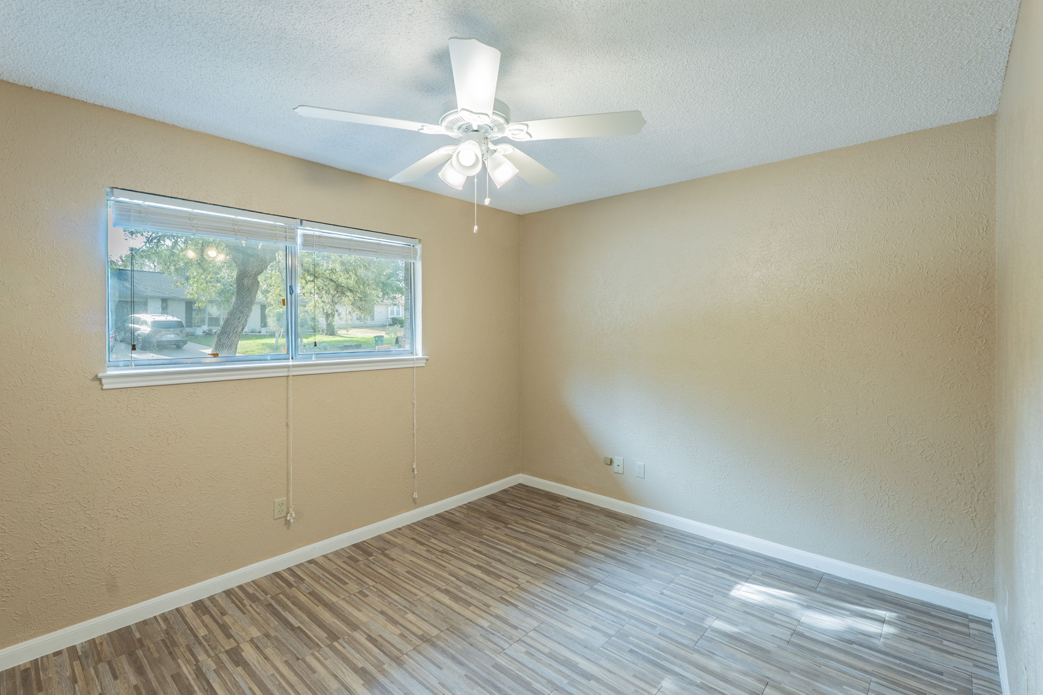 5628 Wagon Train Road Austin, TX 78749 - Photo 15 of 26 Natural light streams through a wide window onto clean plank flooring.