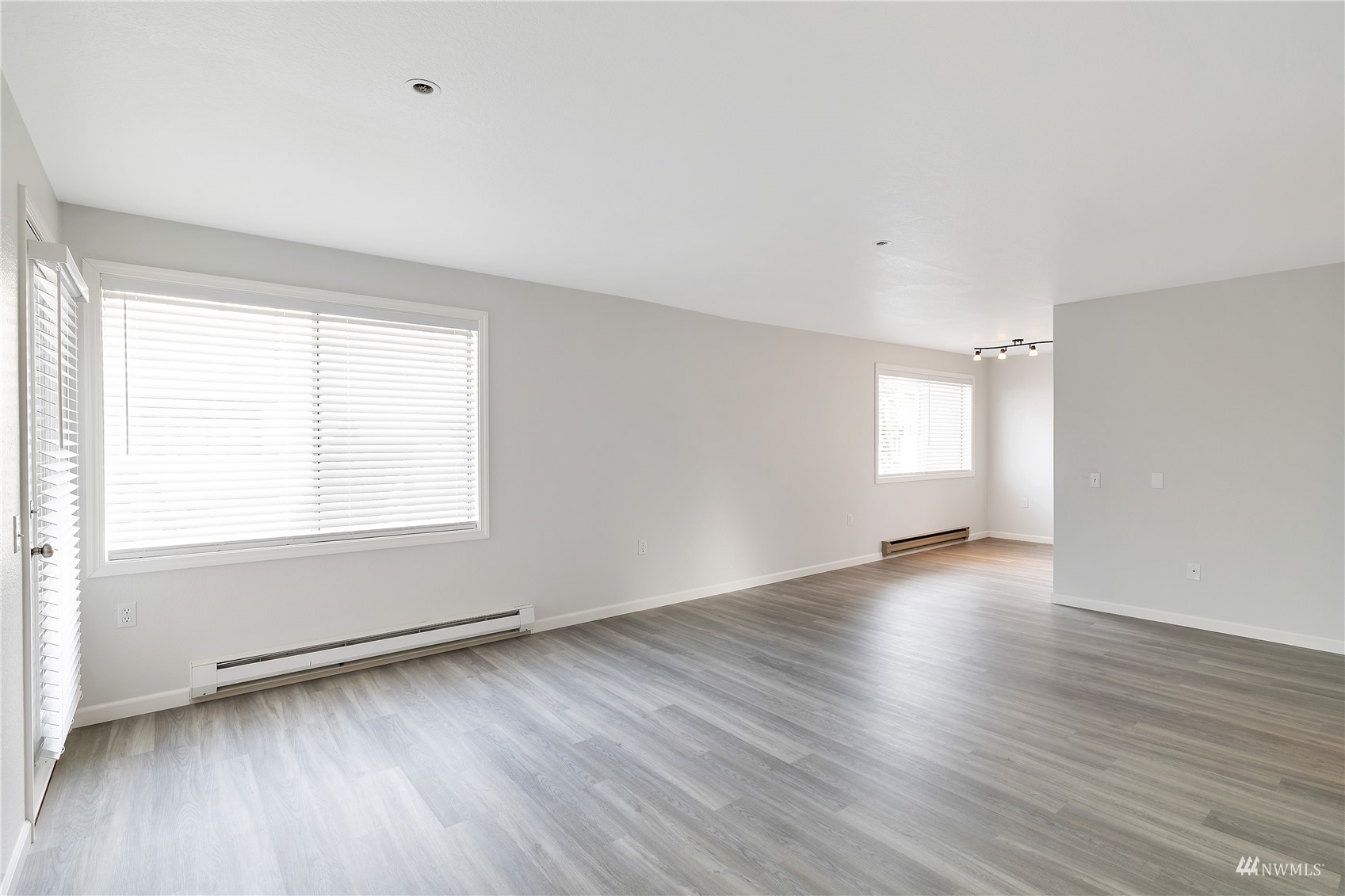 2619 Rucker Avenue, Unit 1 Everett, WA 98201 - Photo 11 of 19 an empty room with wooden floor and windows