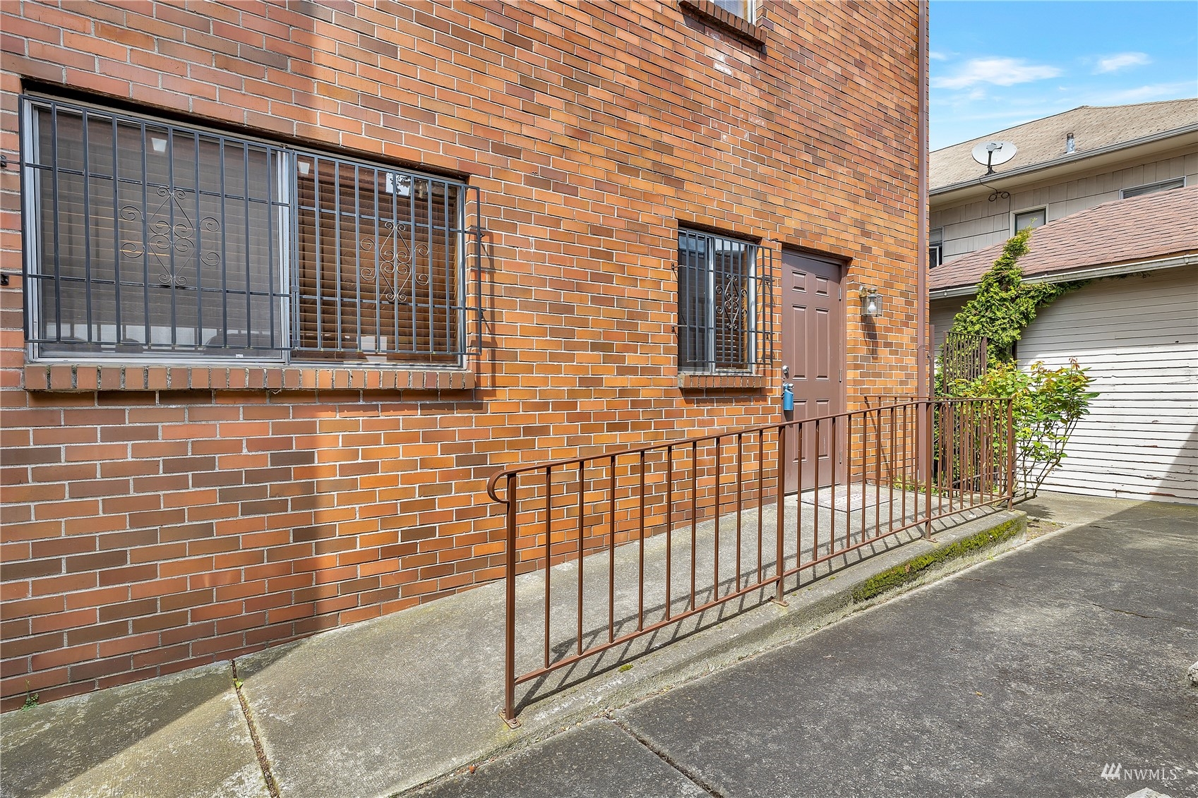 2619 Rucker Avenue, Unit 1 Everett, WA 98201 - Photo 17 of 19 a view of a brick house with wooden fence