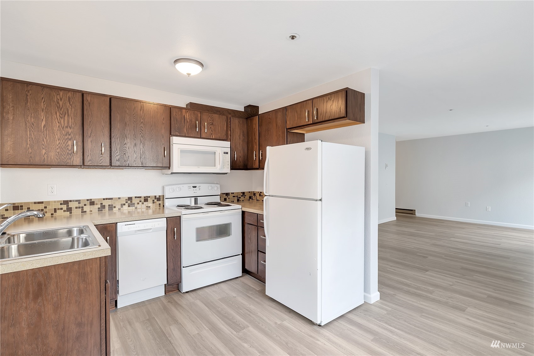 2619 Rucker Avenue, Unit 1 Everett, WA 98201 - Photo 5 of 19 a kitchen with a refrigerator a stove and wooden floor