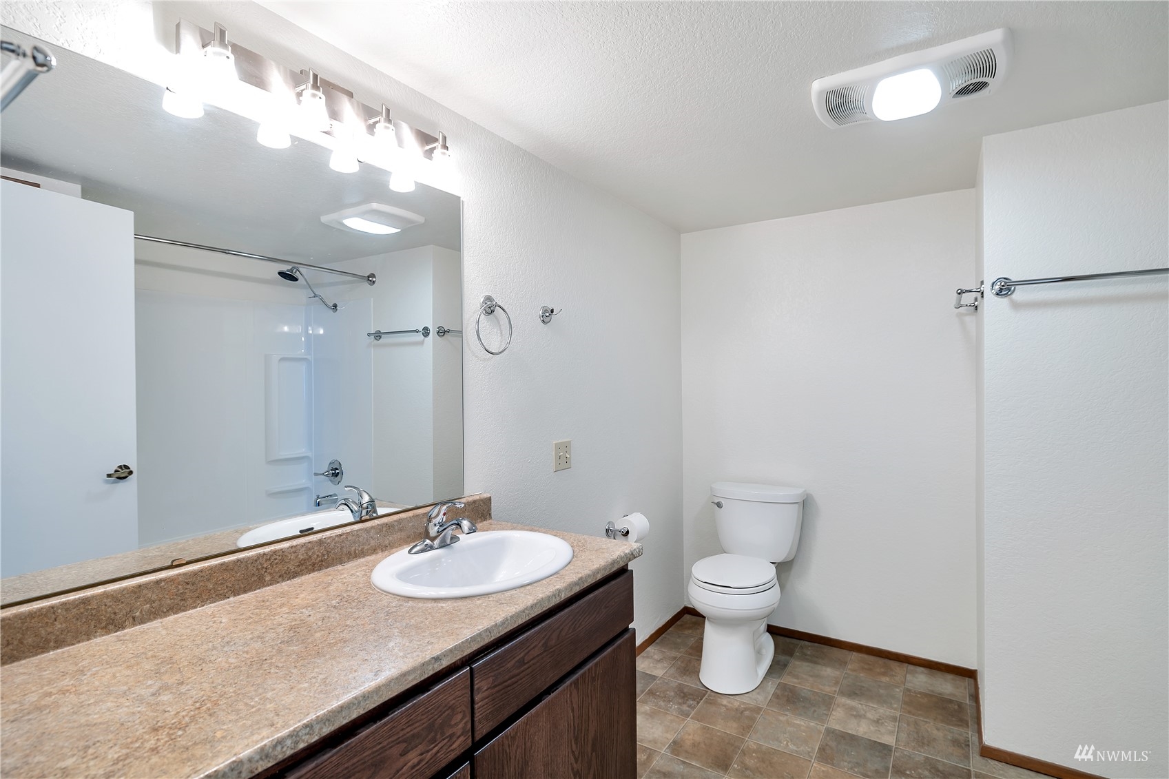 2619 Rucker Avenue, Unit 1 Everett, WA 98201 - Photo 9 of 19 a bathroom with a granite countertop sink a toilet a mirror and a shower
