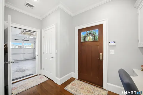 a view of a hallway with wooden floor and glass door