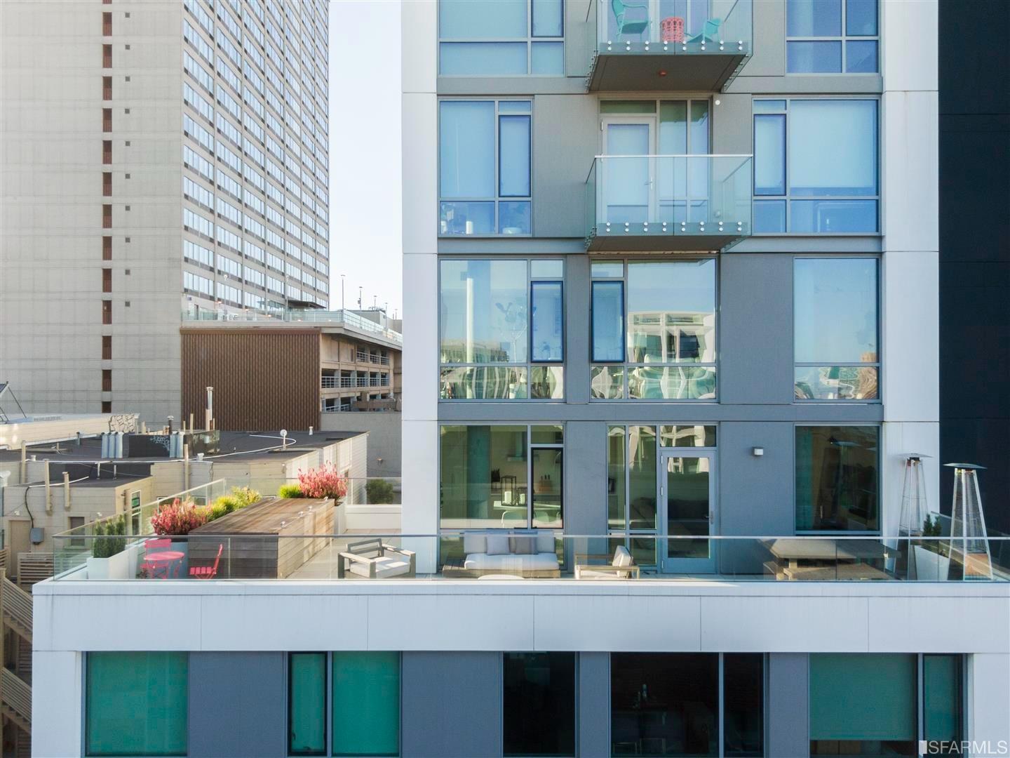 a kitchen view with table and chairs in front of building
