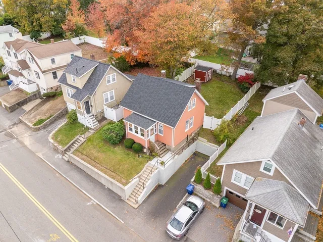 an aerial view of residential house with outdoor space and parking