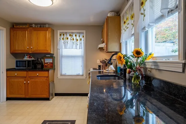 a kitchen with stainless steel appliances a counter top space and cabinets