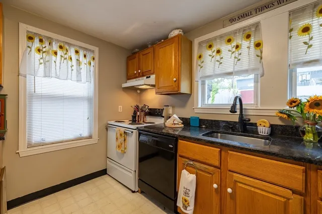 a kitchen with stainless steel appliances a sink a stove and a window