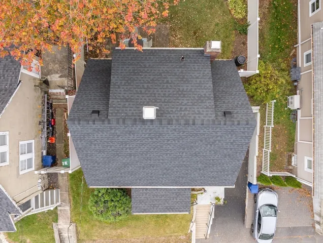 aerial view of a house with a yard and potted plants