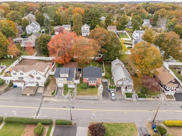 an aerial view of residential houses with yard