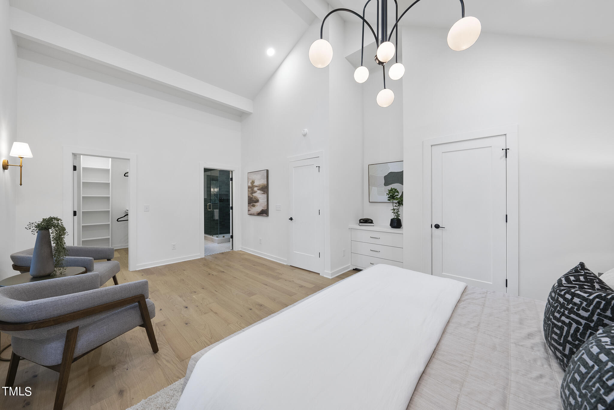 3413 Horton Street Raleigh, NC 27607 - Photo 27 of 45 a spacious bedroom with a bed and chandelier
