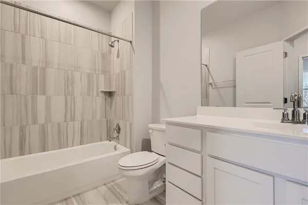 a view of washer and dryer with kitchen in the background