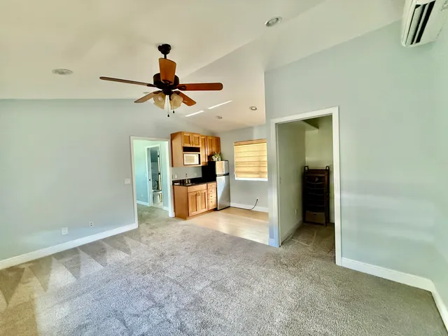 a view of a kitchen with a sink and a refrigerator
